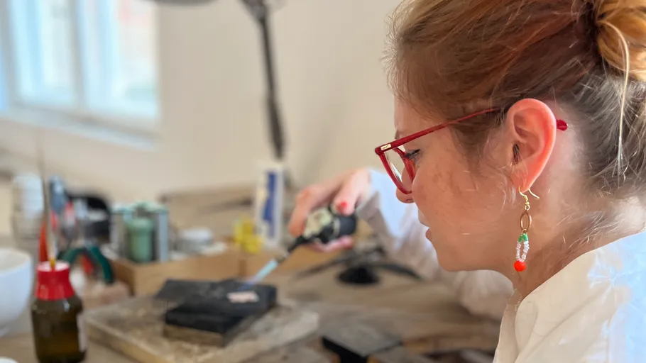 Woman working with tool in a workshop.