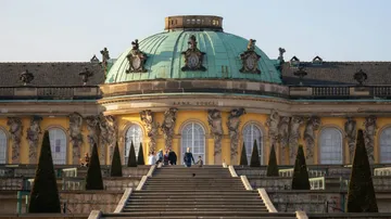 People ascending stairs at Sanssouci Palace.
