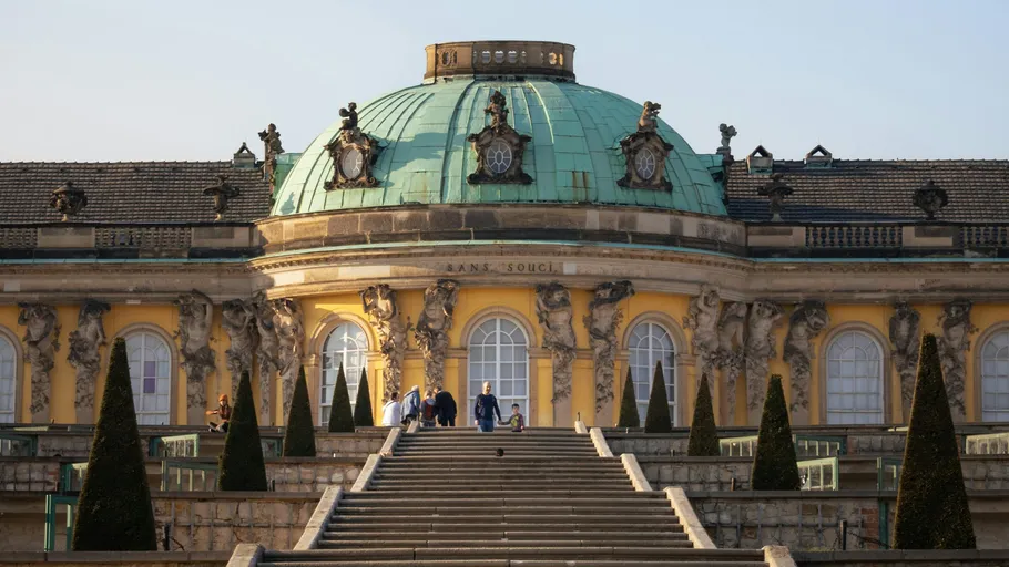 People ascending stairs at Sanssouci Palace.