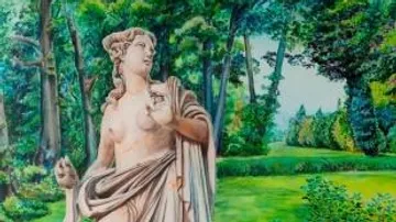 Marble statue in lush forest setting.