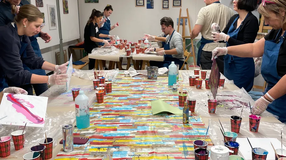 People painting in an art studio workshop.