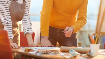 Two people collaborating at a desk.