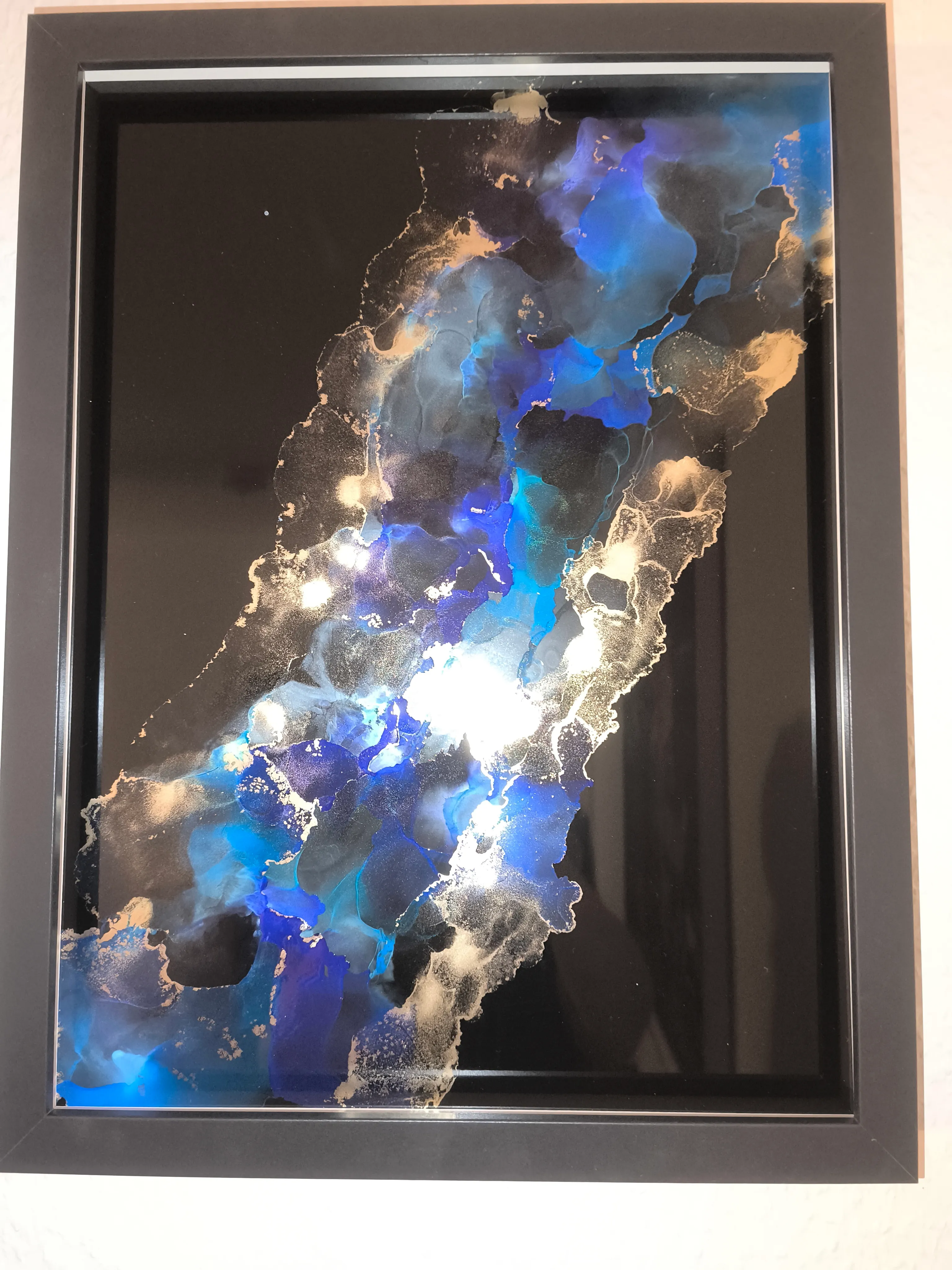 Abstract painting with blue and gold colors.