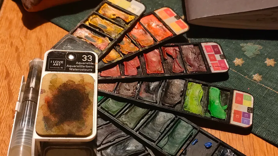 Watercolor paint set with multiple color palettes.