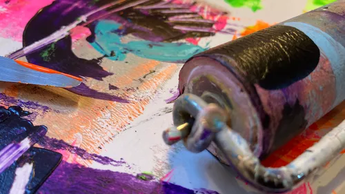 Paint roller and colors on canvas.