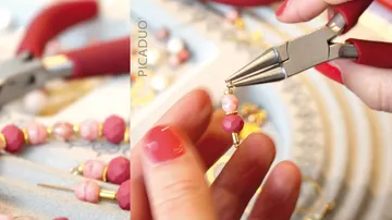 Hand using pliers to make bead jewelry.