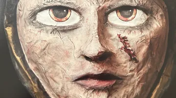 Sculpted face with intense eyes, scarred cheek.