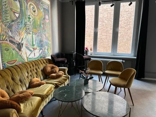 Colorful living room with art and seating.