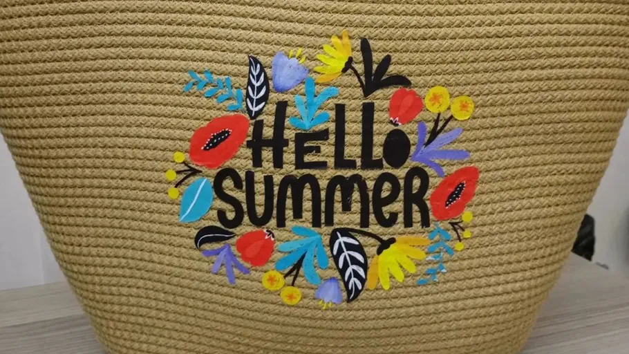Woven bag with 'Hello Summer' and floral design.