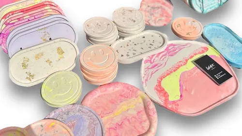 Colorful trays and coasters with various designs.