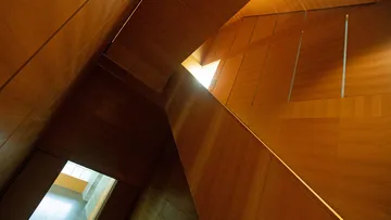 Wooden interior with geometric light openings.