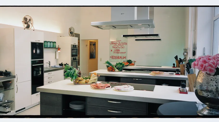 Modern kitchen with island and cooking utensils.