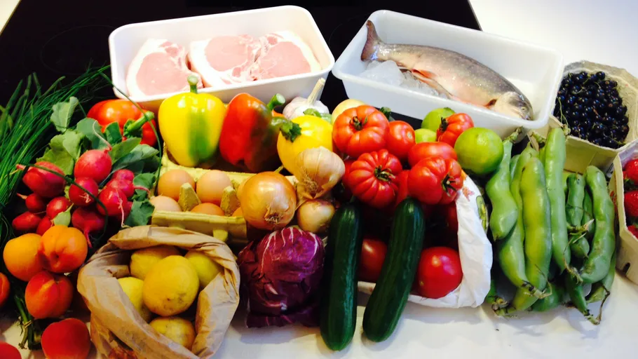 Colorful produce, meat, and fish on a table.