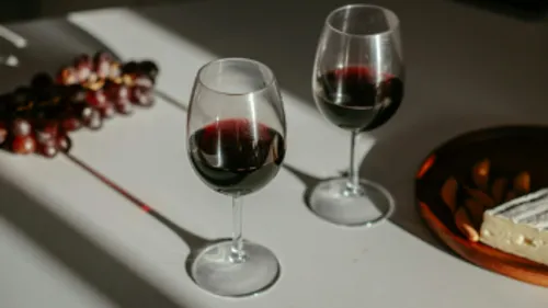 Two glasses of red wine on table.