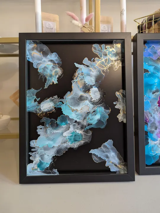 Abstract art with blue and gold on black.