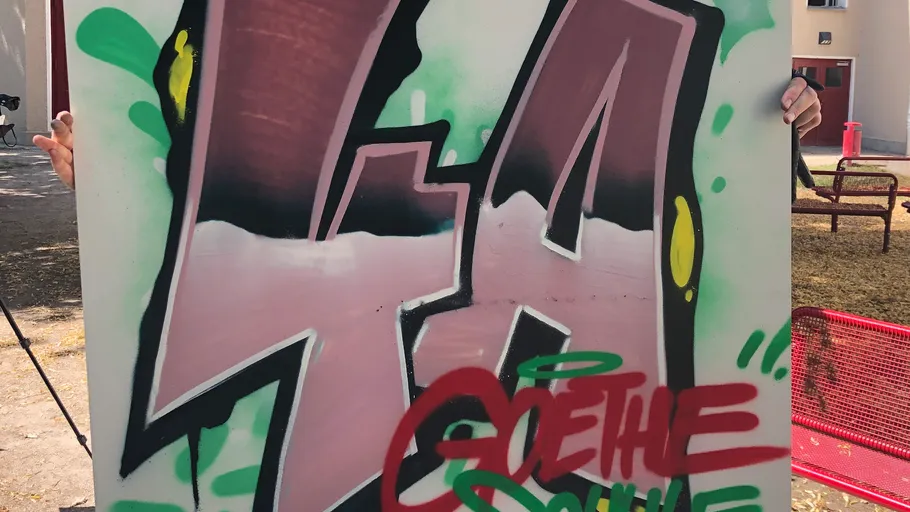 Graffiti art on board, outdoor background.