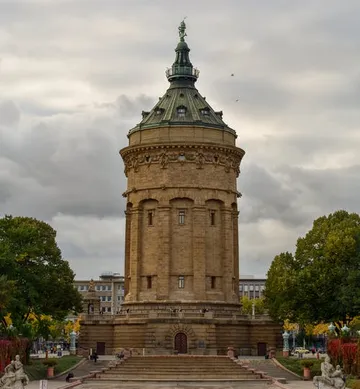 The round tower stands majestically in a park.