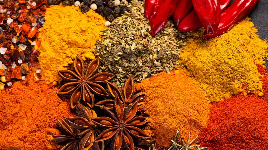 Various colorful spices arranged closely together.