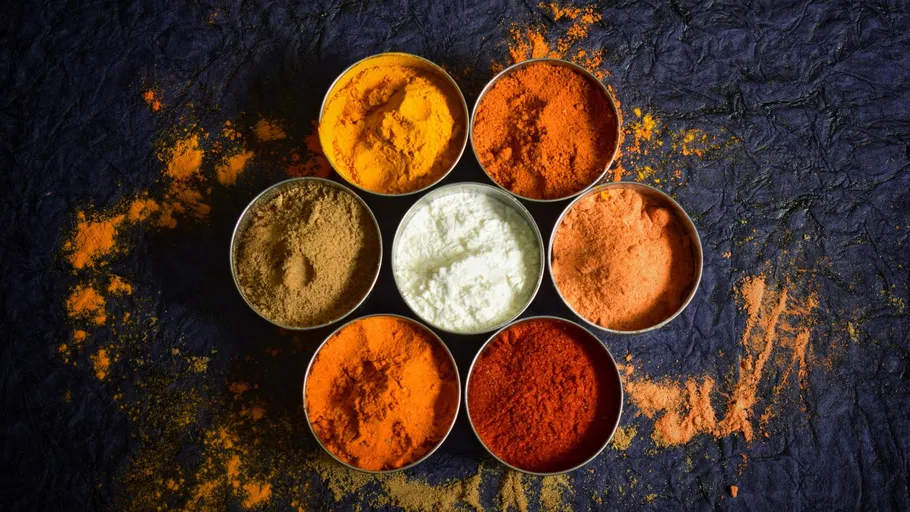 Colorful spices arranged in a circular pattern.