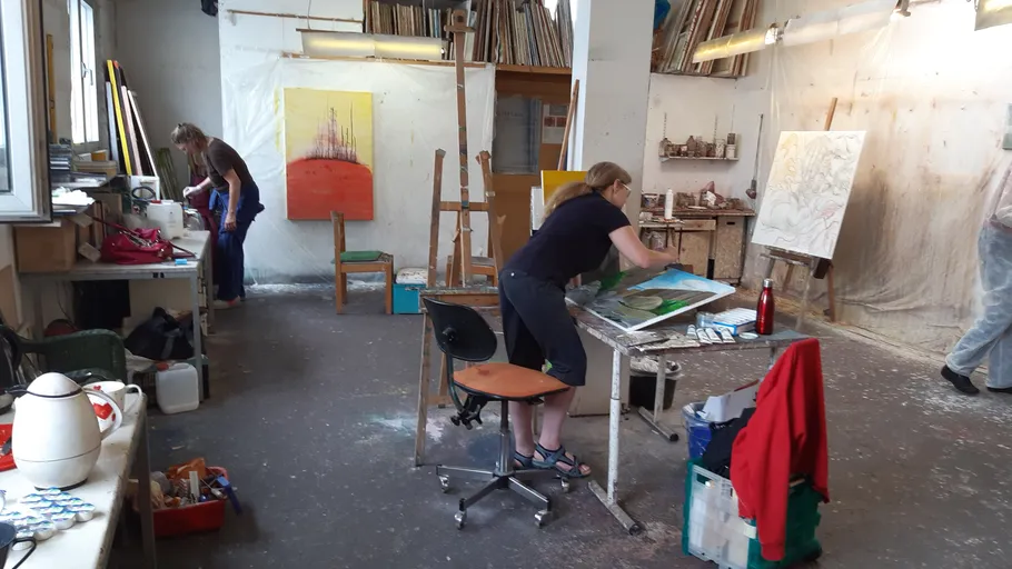 Artists working in a spacious studio.