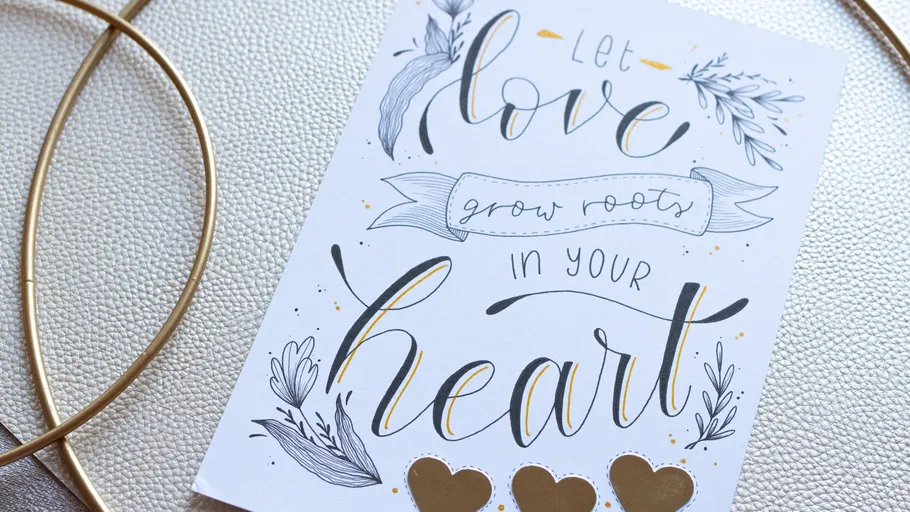 Decorative card with love quote and golden hearts.