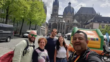 Group smiling in front of a cathedral.
