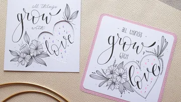 Two cards with floral heart designs on table.