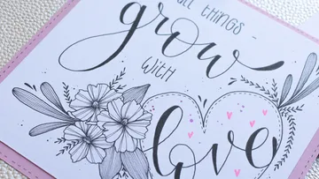 Handwritten quote with flowers on a card.