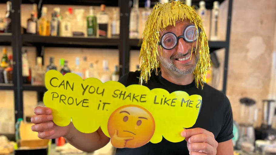 Person with silly costume holds funny sign.