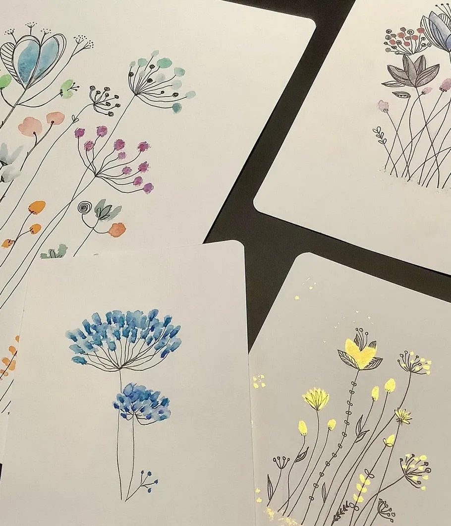 Handgezeichnete Blumendesigns auf weißen Karten.