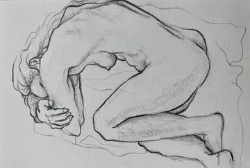 Sketch of curled figure on paper.