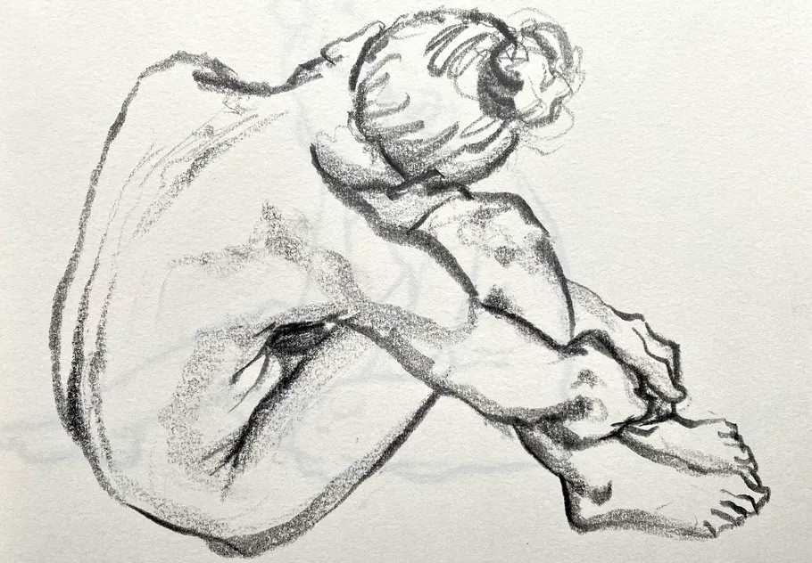 Charcoal sketch of seated person, hugging knees.