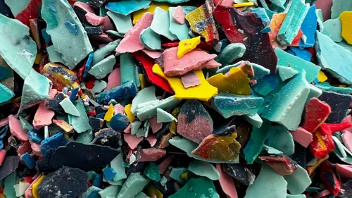 Colorful plastic flakes scattered close-up.