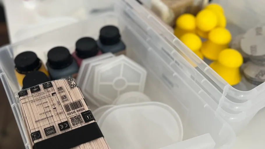 Craft supplies in a plastic storage box.