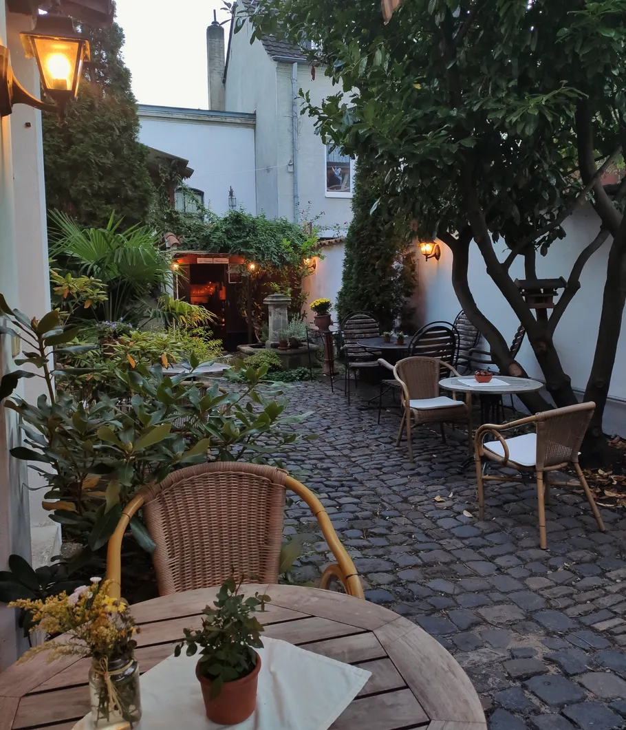 Cozy outdoor patio with tables and chairs.