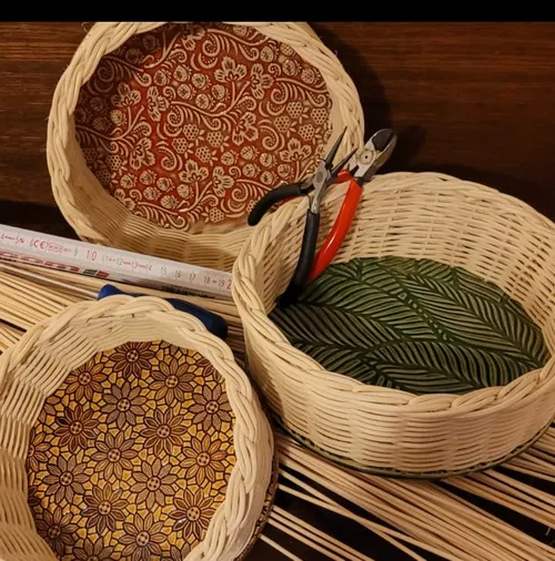 Three wicker baskets with colorful designs inside.