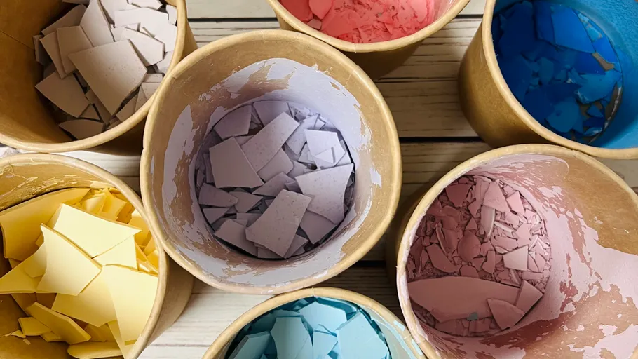 Colorful shards in cardboard containers on table.