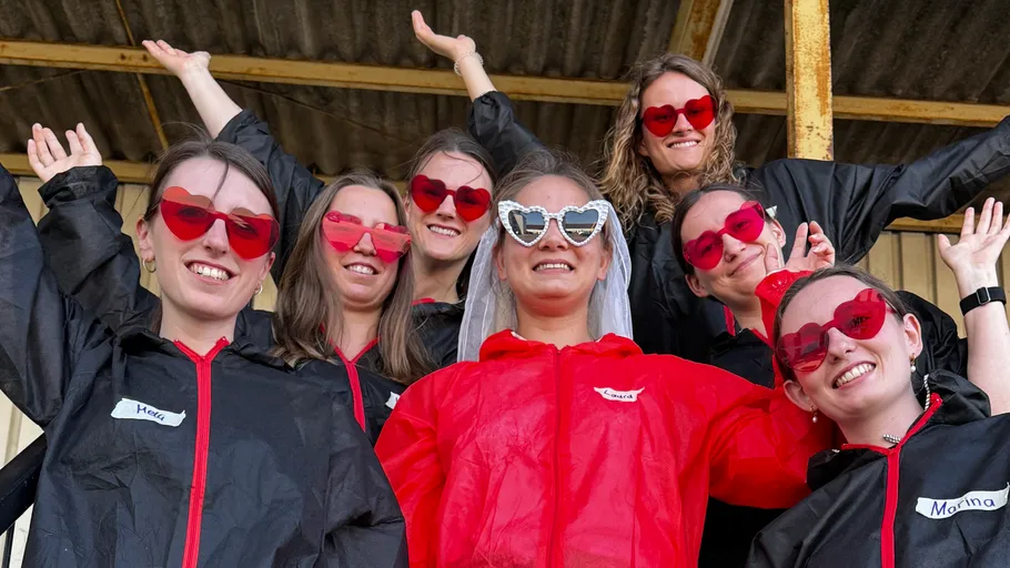 Women wearing heart sunglasses, posing cheerfully.