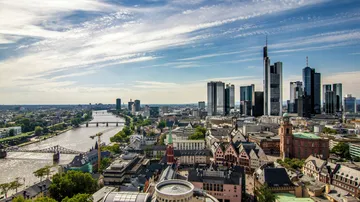 Skyline with river and skyscrapers in city.