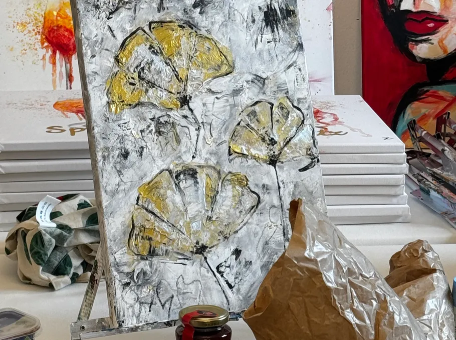 Canvas with abstract yellow flowers in studio.