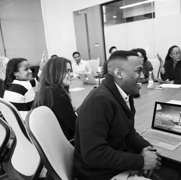 Diverse group discussing in conference room.