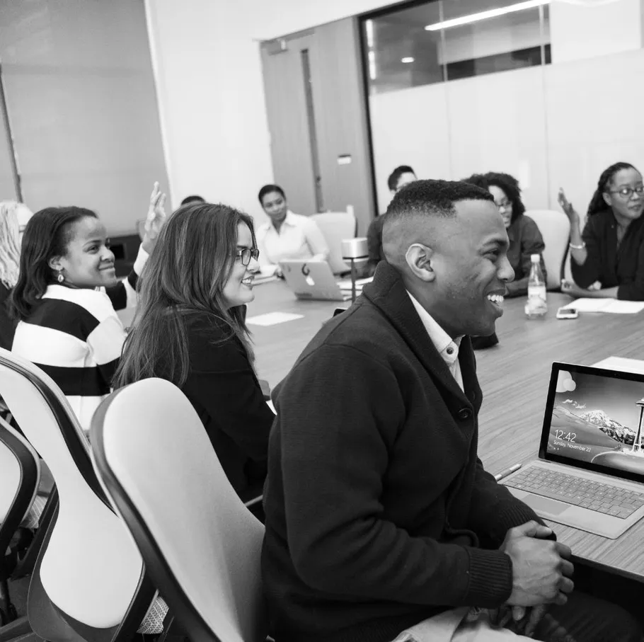 Diverse group discussing in conference room.