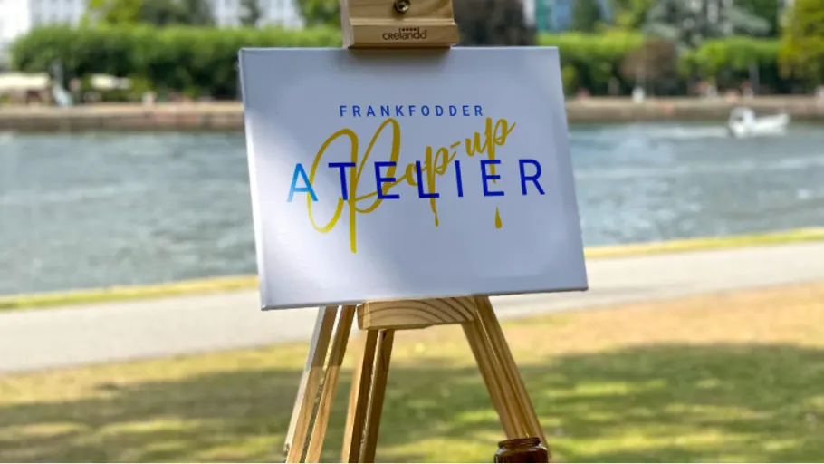 Canvas on easel by riverside park.