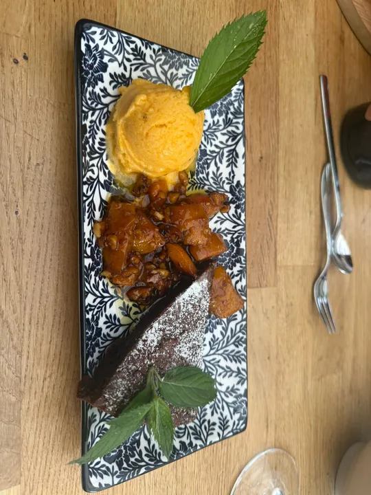 Dessert plate with cake, sorbet, and mint garnish.