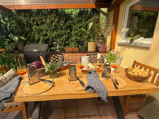 Outdoor table set with graters and drinks.