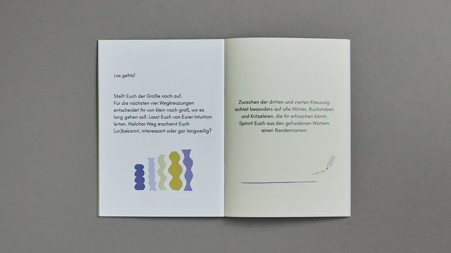 Open booklet with German text on gray surface.