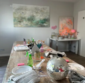 Art supplies on table in studio workshop.