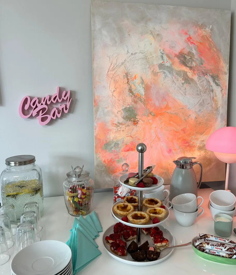 Candy bar with sweets, drinks, and pastries.