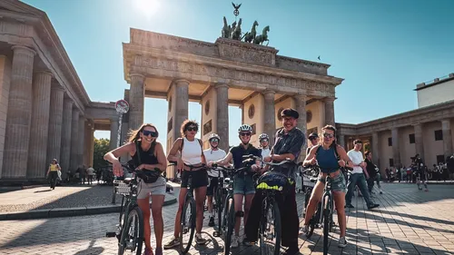 Group on bicycles in front of Brandenburg Gate.