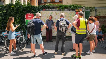 Group gathered around guide explaining route map.